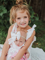 Floral Baby Girls Bow Ruffle Romper - Premium Baby & Toddler Outfits from Rylee Faith Designs - Just $26.95! Shop now at Pat's Monograms